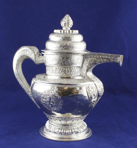 An Indian white metal coffee pot