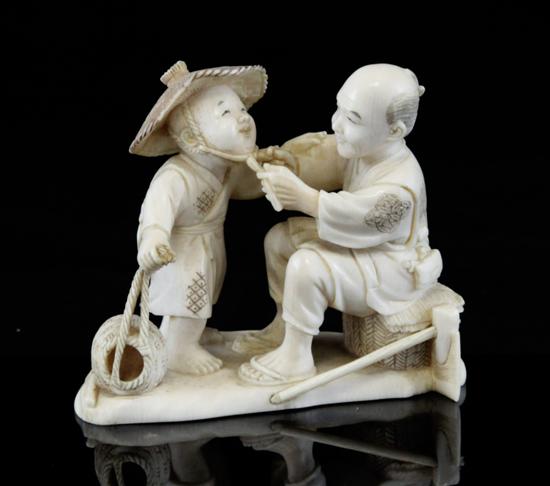 A Japanese ivory group of a woodsman