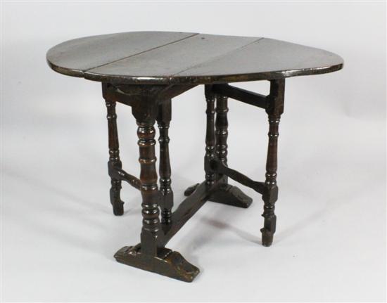 A Charles II oak oval gateleg table