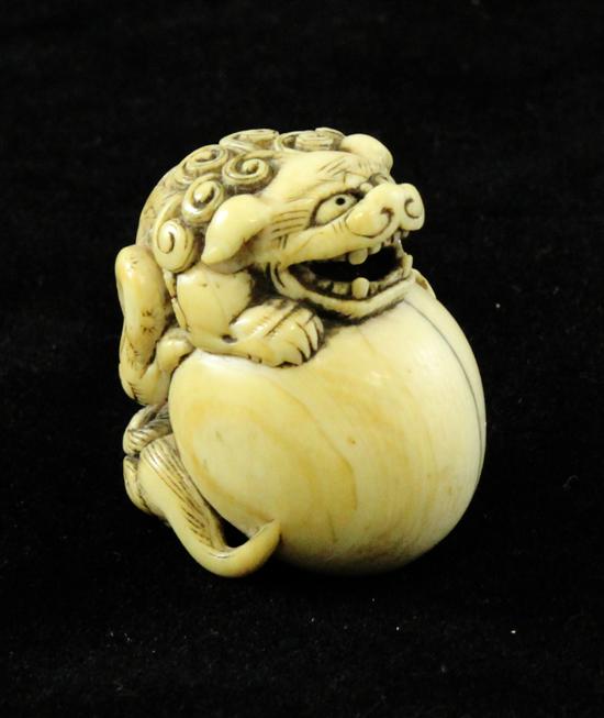 A Japanese ivory netsuke of a shi