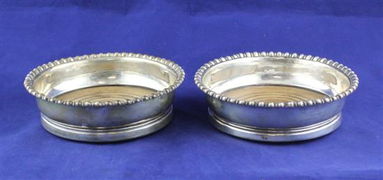 A pair of George III silver coasters 1713ff