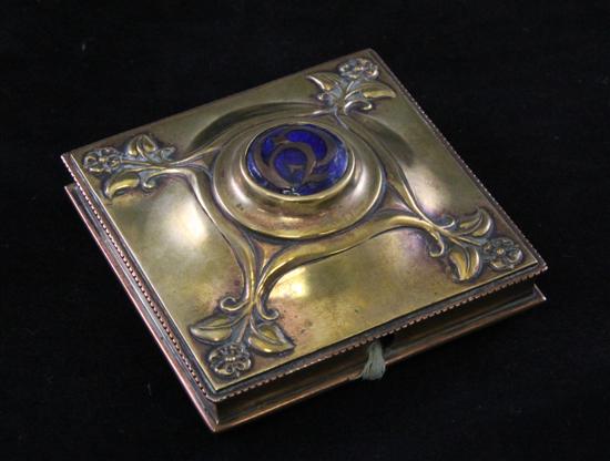 An Art Nouveau brass and enamel