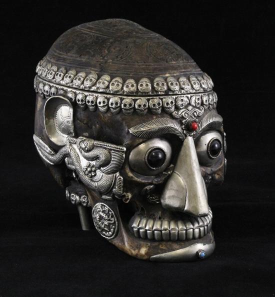 A Tibetan white metal mounted skull