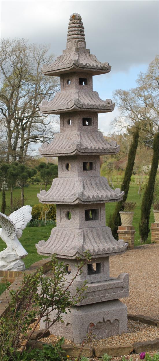 A carved pink granite six tier