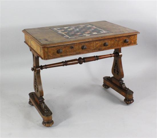 A Victorian walnut games table