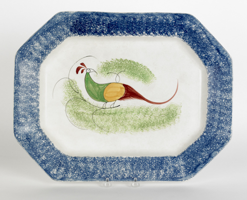 Blue spatter platter with a peafowl
