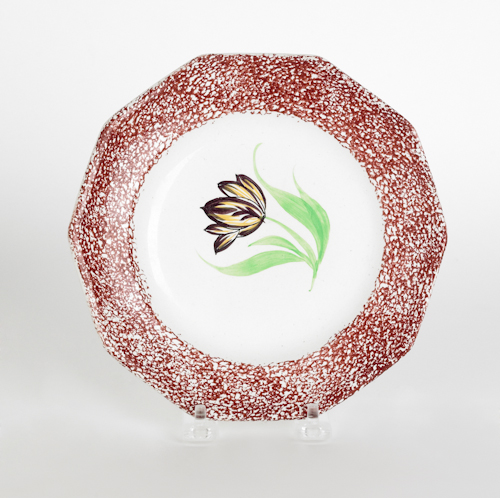 Red spatter plate with a mourning