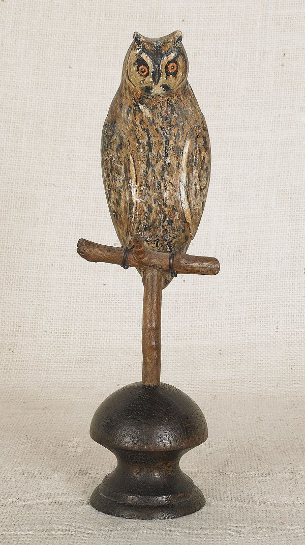 Carved and painted owl on a perch