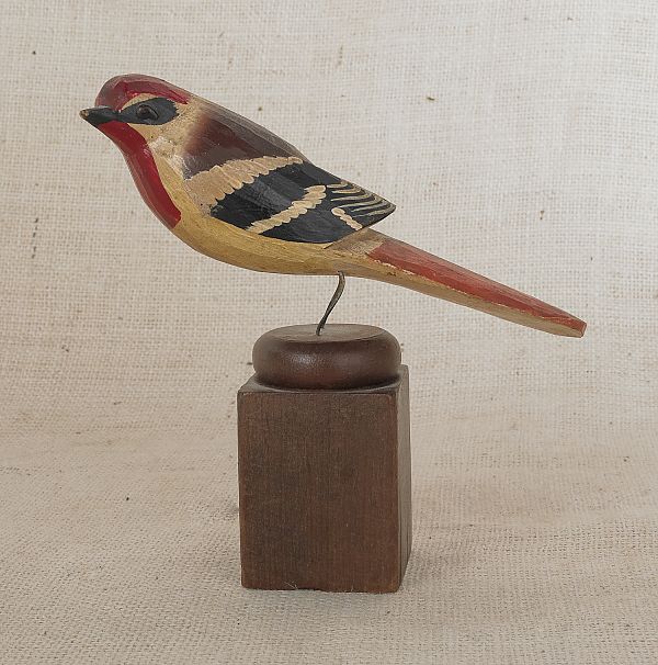 Carved and painted song bird on