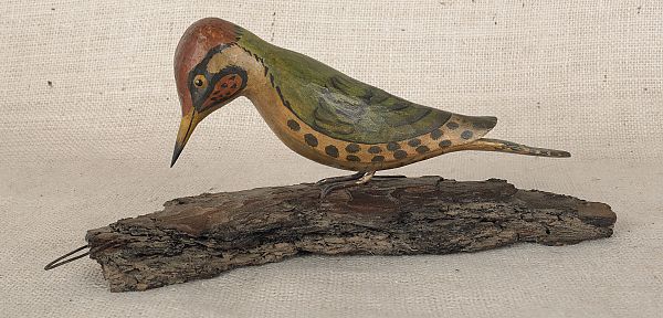 Carved and painted woodpecker late