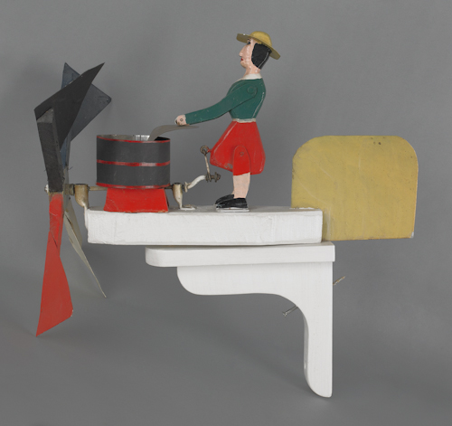 Contemporary whirligig of a woman doing