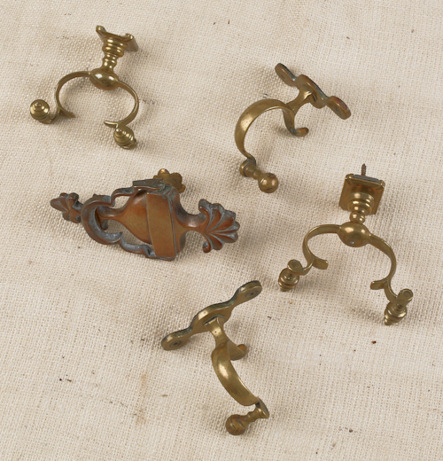 Four brass jamb hooks together with