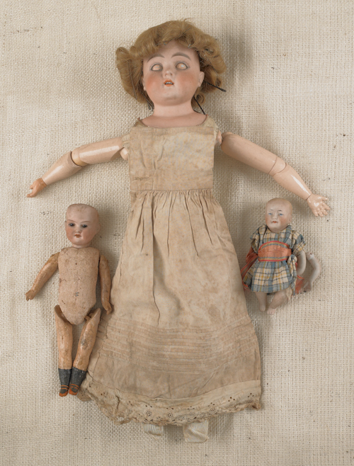 Three bisque head dolls to include one