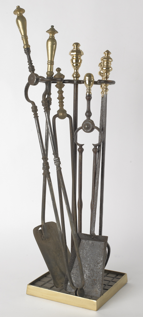 Group of brass and iron fireplace tools.