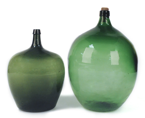 Two green glass demi john bottles 17558d