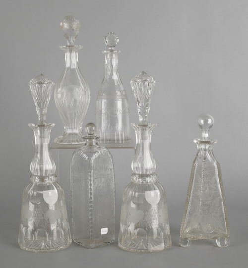 Six etched colorless glass decanters