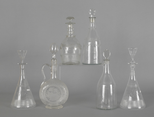 Six colorless glass decanters tallest