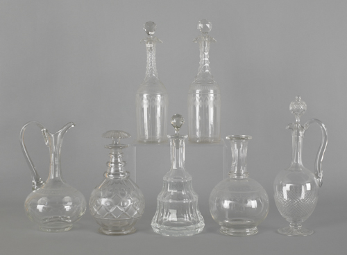 Seven colorless glass decanters