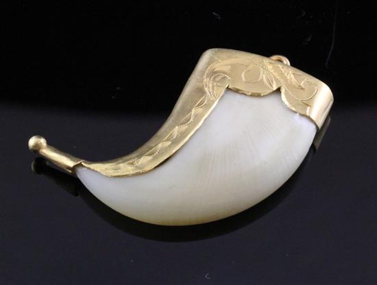 A gold mounted tiger s claw pendant 17334c