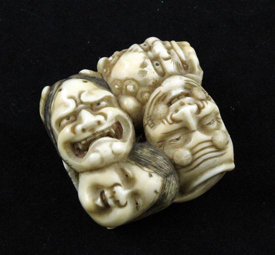 An ivory netsuke carved with seven