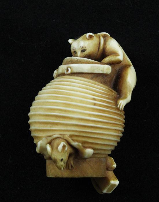 An ivory netsuke carved as a cat hunting