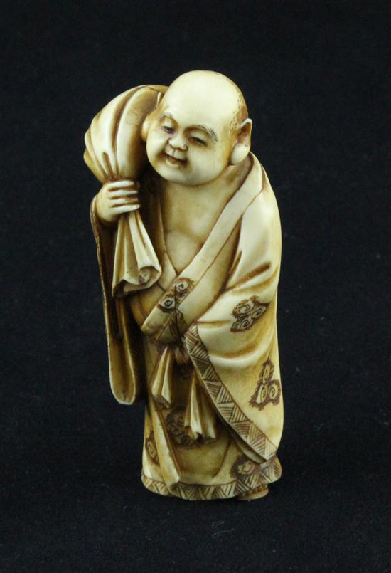 A small Meiji period stained ivory okimono