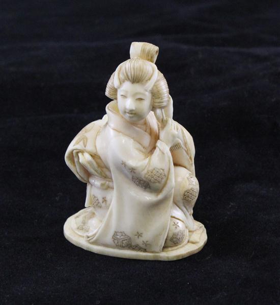 A Japanese ivory figure of a seated