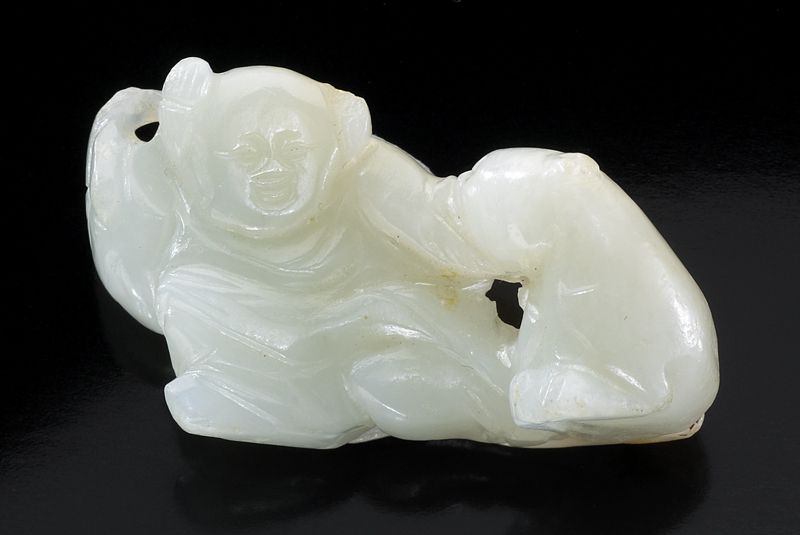 Chinese Qing carved white jade boyplaying