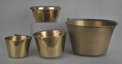 Four brass pots with iron swing