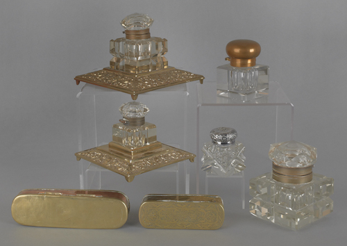 Five brass and cut glass inkwells