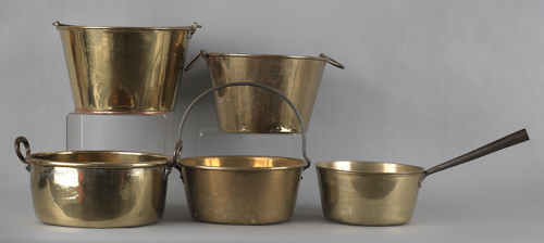 Six brass pots together with a skillet
