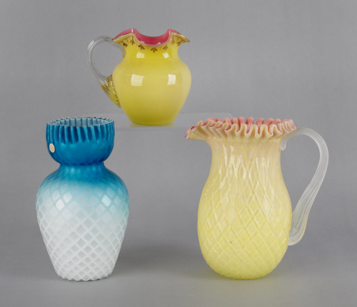 Two overlay glass pitchers one