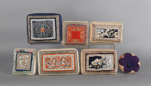 Seven Chinese silkwork pillows.