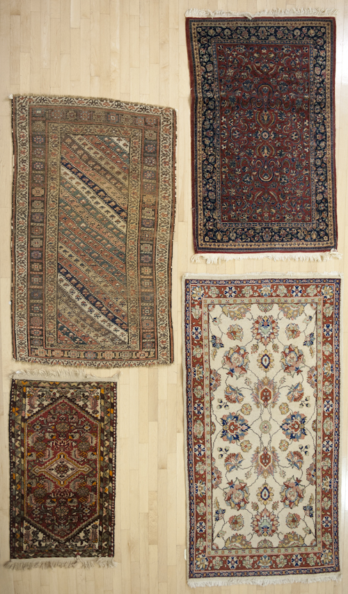 Four oriental throw rugs. ?