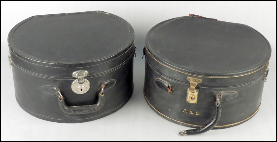 TWO BLACK LEATHERBOUND HAT BOXES.