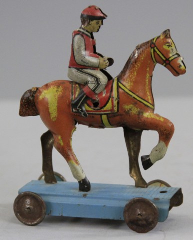 JOCKEY ON HORSE PENNY TOY Germany lithographed