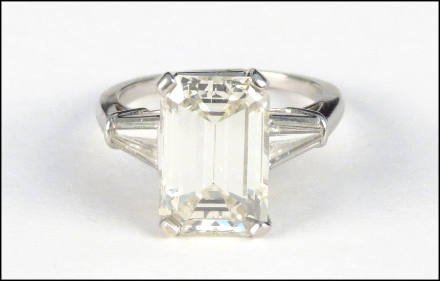 PLATINUM AND DIAMOND RING. Emerald