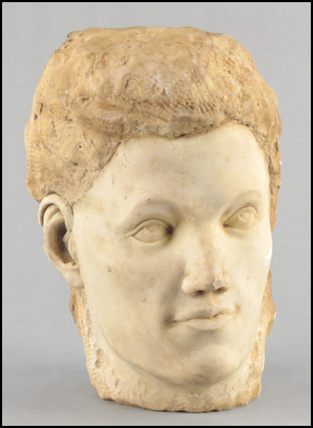 20TH CENTURY CARVED STONE HEAD.