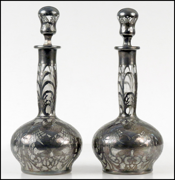 PAIR OF SILVER OVERLAY DECANTERS.