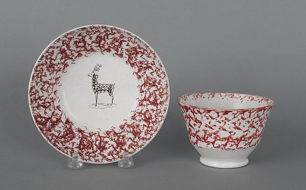Red sponge cup and saucer with a deer