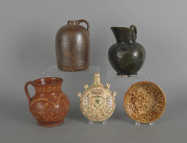 Two redware pitchers together with a