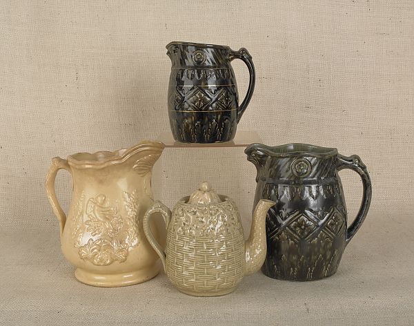 Three pottery pitchers two with