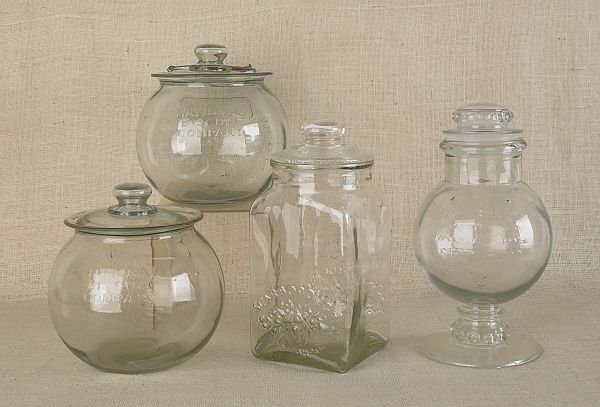 Four colorless glass cookie jars