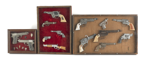 Fourteen framed cap guns 20th c.