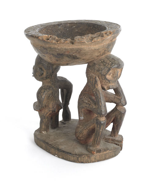 Carved African bowl supported by