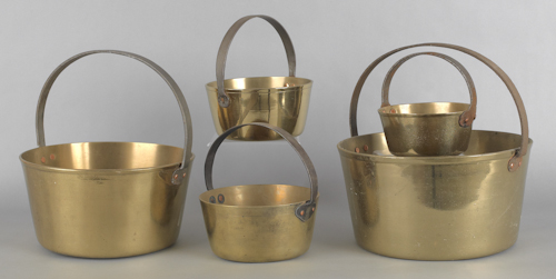 Five brass pots with fixed iron