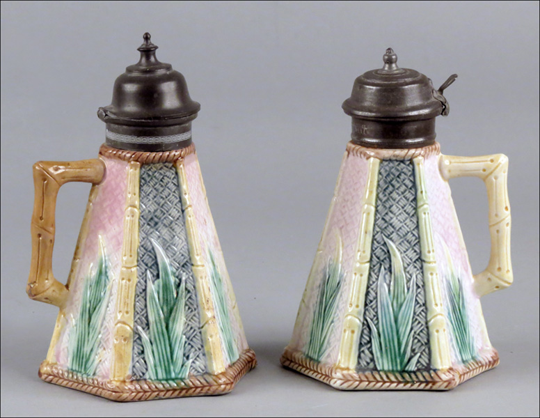 TWO MAJOLICA SYRUP PITCHERS. Condition:
