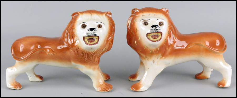 PAIR OF STAFFORDSHIRE LIONS. 19th