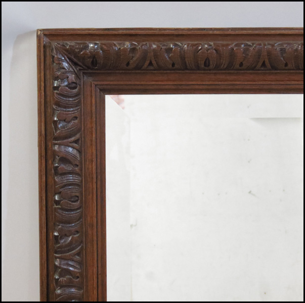 CONTINENTAL CARVED OAK MIRROR.