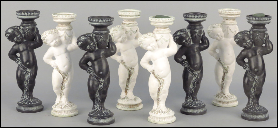 TWO SETS OF COMPOSITE CHERUB CANDLESTICKS.